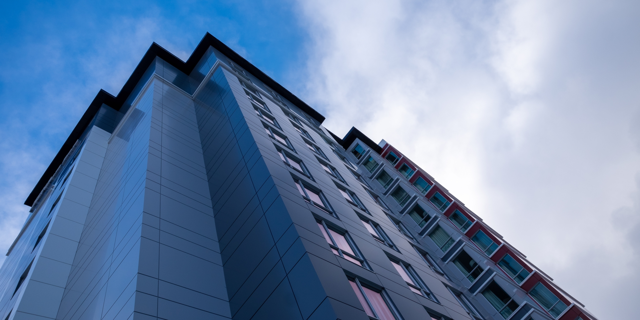 The,Exterior,Wall,Of,A,Contemporary,Commercial,Style,Building,With A building standing tall showcasing commercial cladding